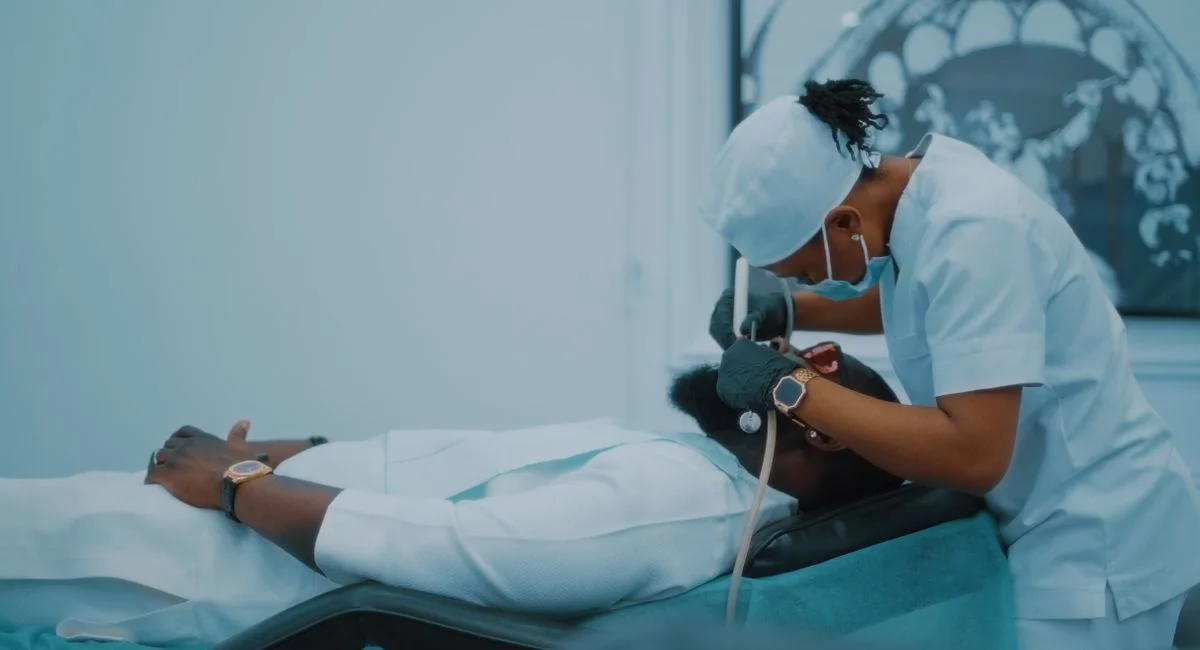 A dental professional performs a procedure on a patient in a Lagos clinic.